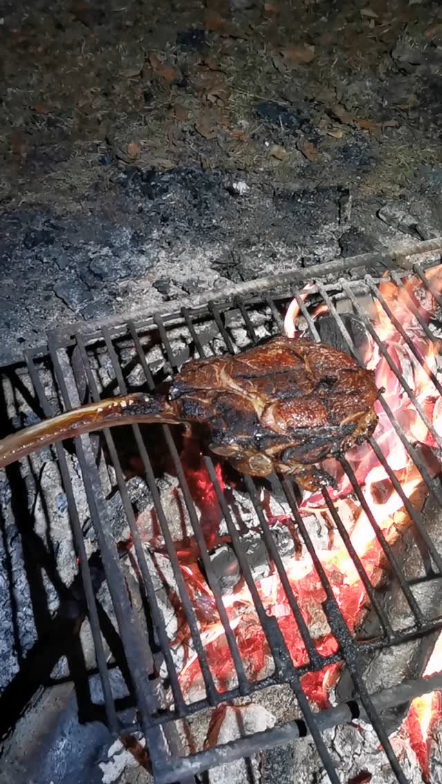 tomahawk steak by the campfire